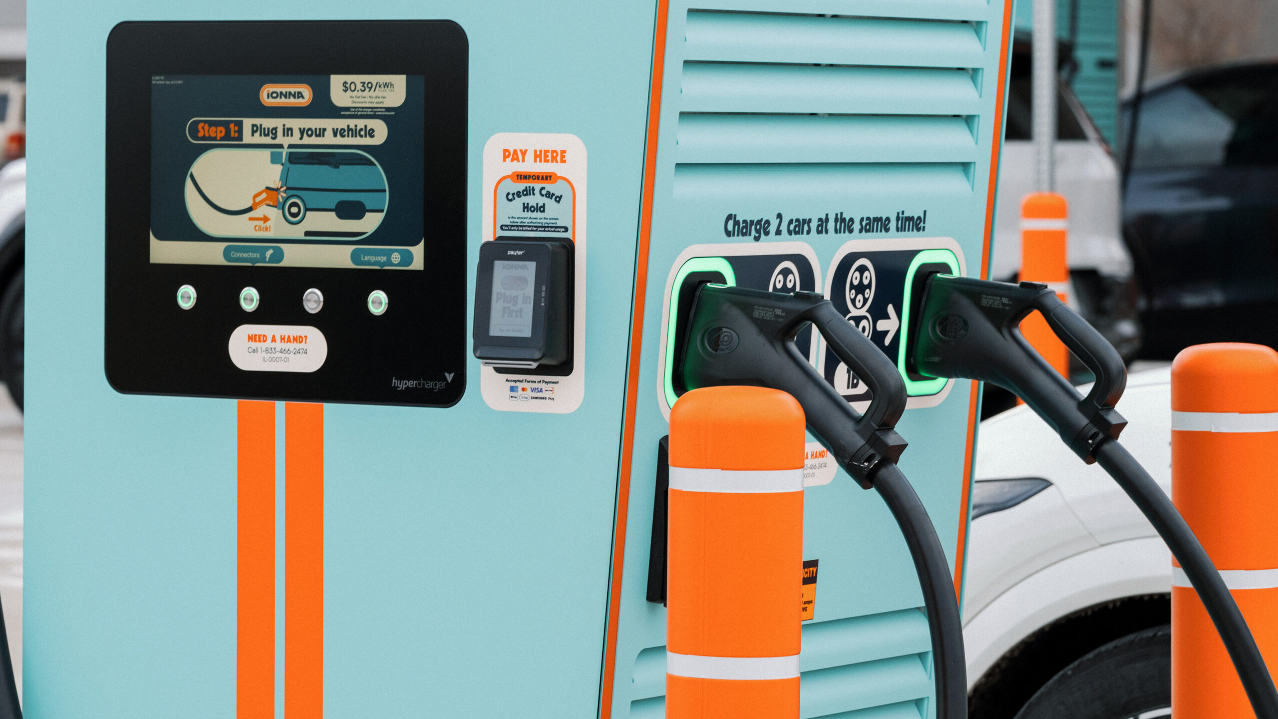An IONNA dispenser with its NACS and CCS connectors at a Rechargery