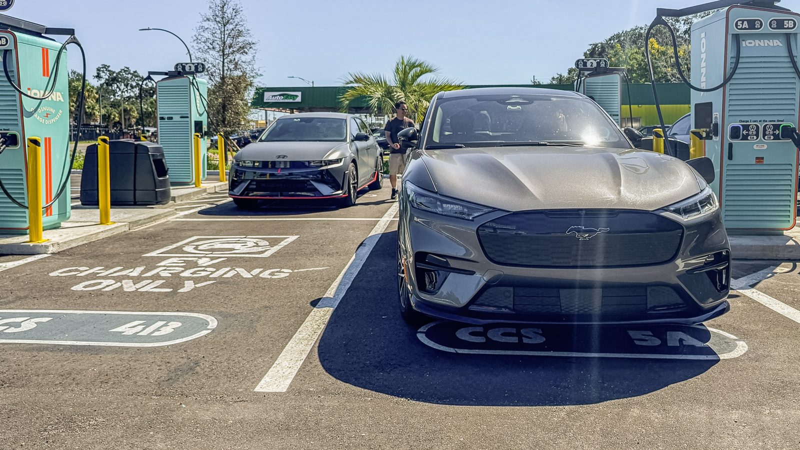 A grey Mustang Mach-E charging in a CCS bay with a Hyundai Ioniq 5 N parked behind it
